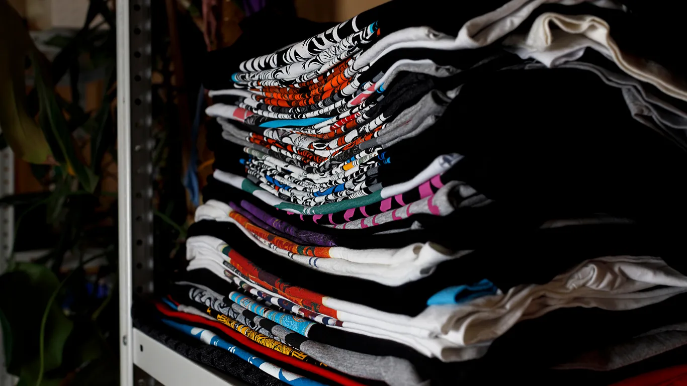 Stack of folded animal print t-shirts from Soxybull meaningful fashion collection